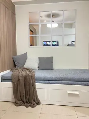a bed with a mirror above it in a room at La Casa de Maria in Manila