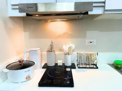 a kitchen counter with a stove with a pot on it at Air Residences Makati in Manila