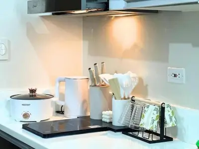 a kitchen counter with various appliances on it at Air Residences Makati in Manila