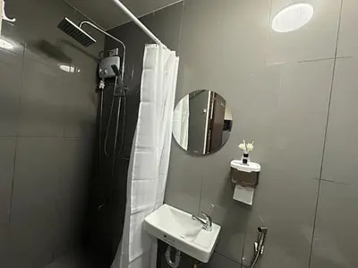 a bathroom with a sink and a mirror at Air Residences Makati in Manila