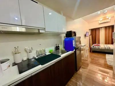 a kitchen with a sink and a counter top at Air Residences Makati in Manila