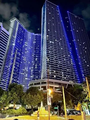 a large building with blue lights in front of it at Air Residences Makati in Manila