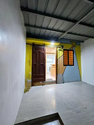 an empty room with a wooden door and a hallway at Tiny home in Naic in Naic