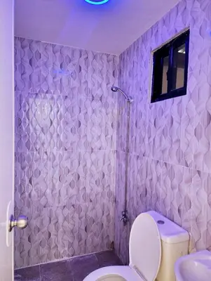 a purple bathroom with a toilet and a shower at Tiny home in Naic in Naic