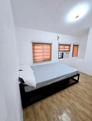 a bedroom with a large bed in a room at Tiny home in Naic in Naic