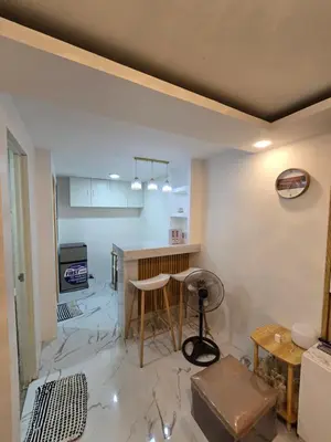 a living room with a table and a kitchen at Tiny home in Naic in Naic
