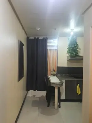 a bathroom with a sink and a black shower curtain at Birch Tower Malate Manila by T&T in Manila