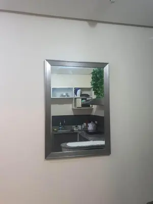 a mirror on a wall with a sink in it at Birch Tower Malate Manila by T&T in Manila