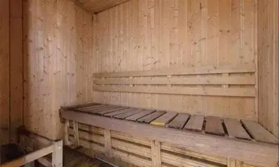 a wooden cabin with a bed in the corner at Birch Tower Malate Manila by T&T in Manila
