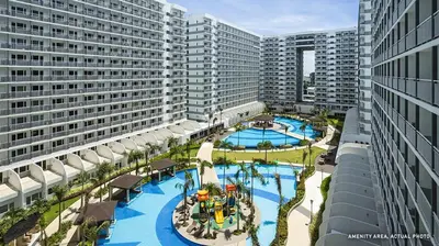 an overhead view of a large swimming pool with buildings at Relax and Unwind A Homey Escape Near MOA and NAIA in Manila