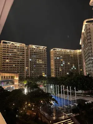 a view of a city at night with tall buildings at Staycation In Azure Parañaque in Manila