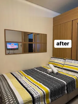 a bedroom with two beds and a tv at Macc staycation in Manila