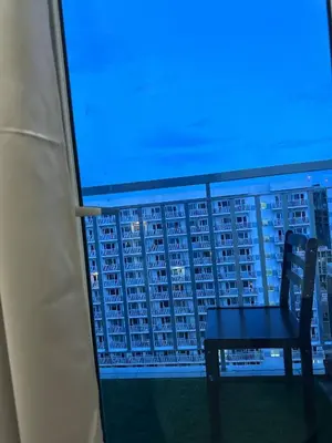 a chair sitting on the balcony of a building at Macc staycation in Manila