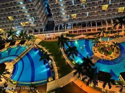an overhead view of a large hotel with two pools at Macc staycation in Manila