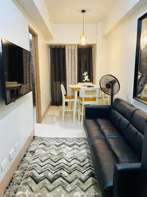 a living room with a couch and a table at SMDC Shore 3 Residences in Manila