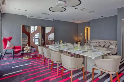 a dining room with a long table and chairs at Amira Luxury at Novotel Suites Manila near Makati and BGC in Manila