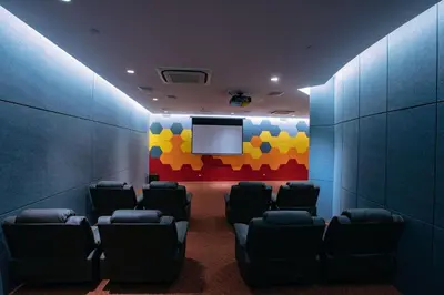 a waiting room with chairs and a flat screen tv at Amira Luxury at Novotel Suites Manila near Makati and BGC in Manila