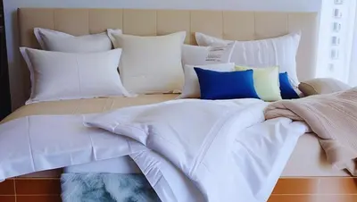a white bed with a bunch of pillows on it at 2BR Pioneer Woodland connected to Metro Rail Station SM Light,BONI Mandaluyong, Metro Manila,Philippines in Manila