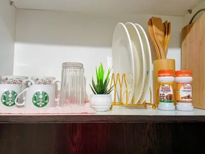 a shelf with plates and utensils on it at 1BR Covent Garden South Tower University Belt- SM Sta Mesa, Metro Manila,Philippines in Manila