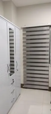a bathroom with a shower and a window in it at Reden Staycation in Manila