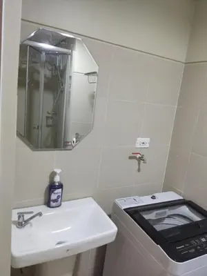 a small bathroom with a sink and a stove at Reden Staycation in Manila