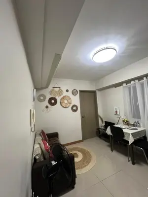 a living room with a couch and a table at Faerydae Suites - Free Pool Access in Manila