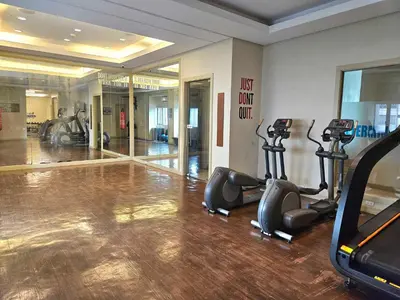 a gym with treadmills and exercise equipment in a room at Lil' Olive Spot at SOHO Central Condo in front of Edsa Shangri-la Mall in Manila