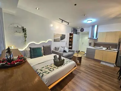 a large living room with a couch and a kitchen at Lil' Olive Spot at SOHO Central Condo in front of Edsa Shangri-la Mall in Manila