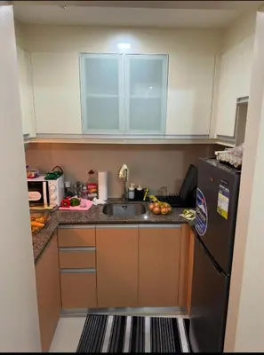 a small kitchen with a sink and a refrigerator at Cluster 6 3D 81 Newport Boulevard in Manila