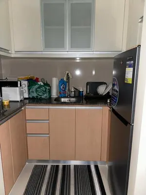 a kitchen with a refrigerator and a sink at Cluster 6 3D 81 Newport Boulevard in Manila