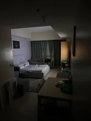 a dark room with a bed and a couch at Cluster 6 3D 81 Newport Boulevard in Manila