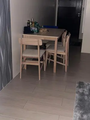 a wooden table and chairs in a room at Cluster 6 3D 81 Newport Boulevard in Manila