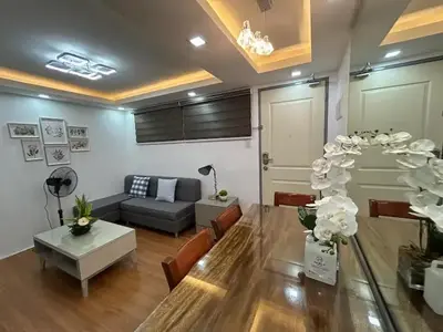 a living room with a couch and a table at Away from but close like family room in Manila