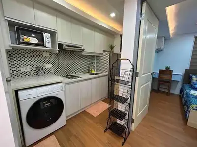 a kitchen with a dishwasher and a stove and a microwave at Away from but close like family room in Manila