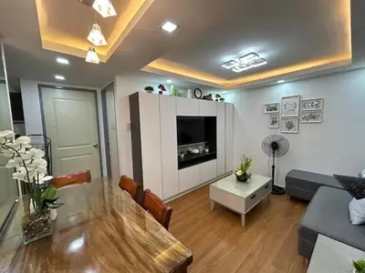 a living room with a couch and a table at Away from but close like family room in Manila