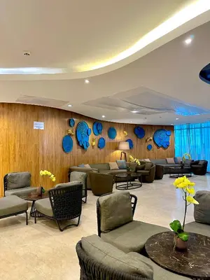 a lobby with chairs and tables and blue mirrors at Casa Nette in Manila