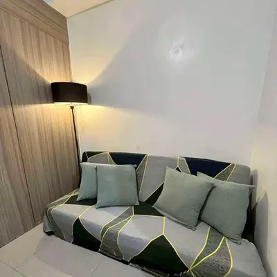 a bed with pillows on it in a room at Casa Nette in Manila