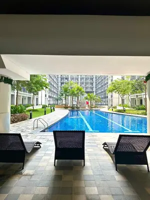 a large swimming pool in a building with benches at Casa Nette in Manila
