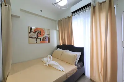a bedroom with a bed with a white animal on it at GM Suite near SM MOA, Pasay I 2 Beds I City & Bay View in Manila