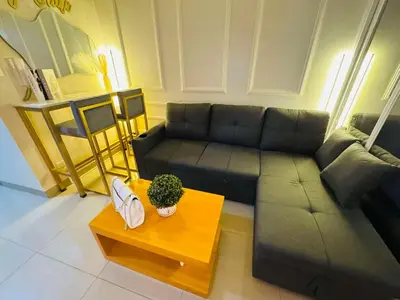 a living room with a couch and a coffee table at GM Suite near SM MOA, Pasay I 2 Beds I City & Bay View in Manila