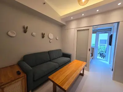 a living room with a couch and a table at Jazz Residence- Makati in Manila