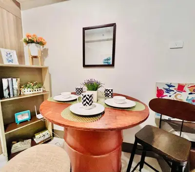a small table with two plates on it in a room at Condo Ortigas CBD in Manila