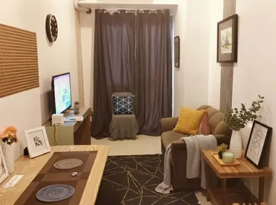 a living room with a couch and a table at SMDC Apartment Ortigas in Manila