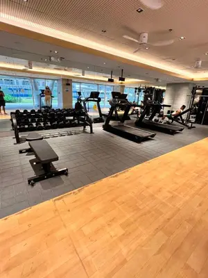 a gym with a bunch of exercise equipment in it at Central Ortigas Center Condo in Manila