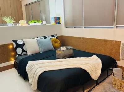 a bedroom with a bed and a couch at Perfect Location BGC - Mckinley in Manila