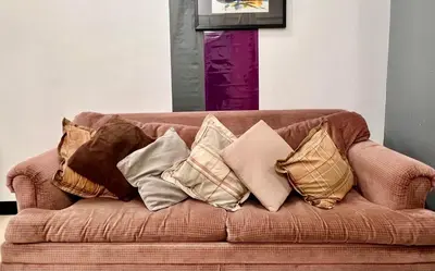 a bunch of pillows sitting on a couch at Perfect Location BGC - Mckinley in Manila