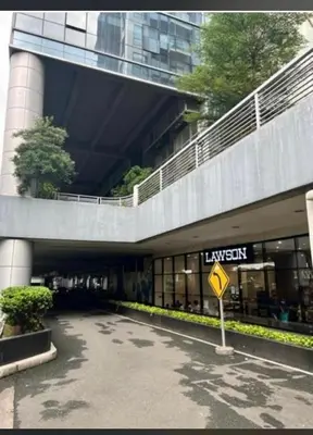 a building with a yellow street sign in front of it at 81 Newport Blvd Cluster 5 Unit 4E by Rechelle Nunag in Manila