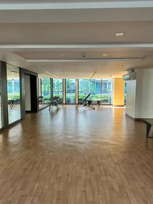 a large empty room with a hardwood floor and windows at 81 Newport Blvd Cluster 5 Unit 4E by Rechelle Nunag in Manila