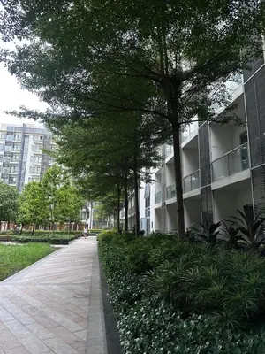a sidewalk in front of a building with trees at 81 Newport Blvd Cluster 5 Unit 4E by Rechelle Nunag in Manila