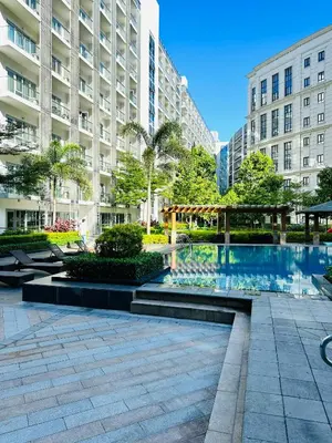 a courtyard with a swimming pool in a building at 81 Newport Blvd Cluster 5 Unit 4E by Rechelle Nunag in Manila